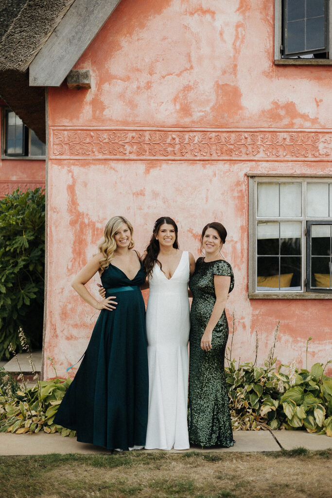 Bride and bridesmaids getting ready at Moat cottage, at the Chapel Barn Estate at Wilderness. Dark Green bridesmaids dresses and beautiful bridal dress from the Wedding Club