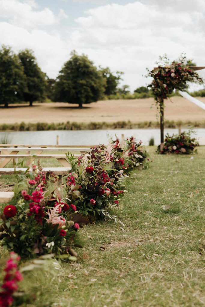 Organic and whimsical meadow arrangements for A & B's outdoor lakeside ceremony at Wilderness Reserve
